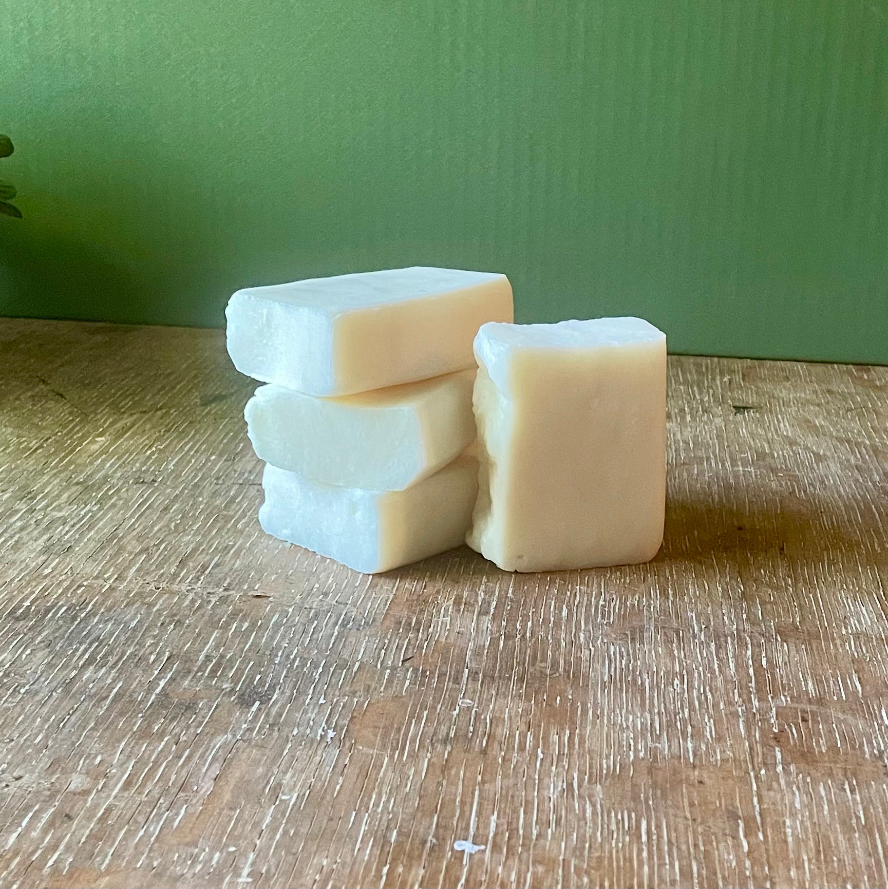Stack of four soap bars, white in color, unscented.