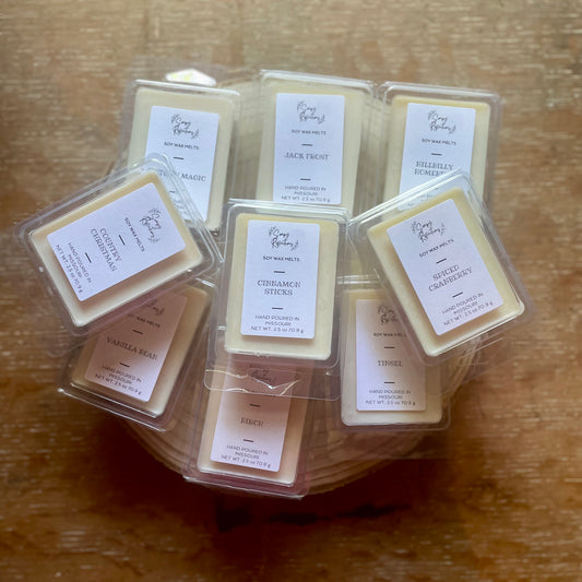 Stack of nine plastic clam shell wax melts. 