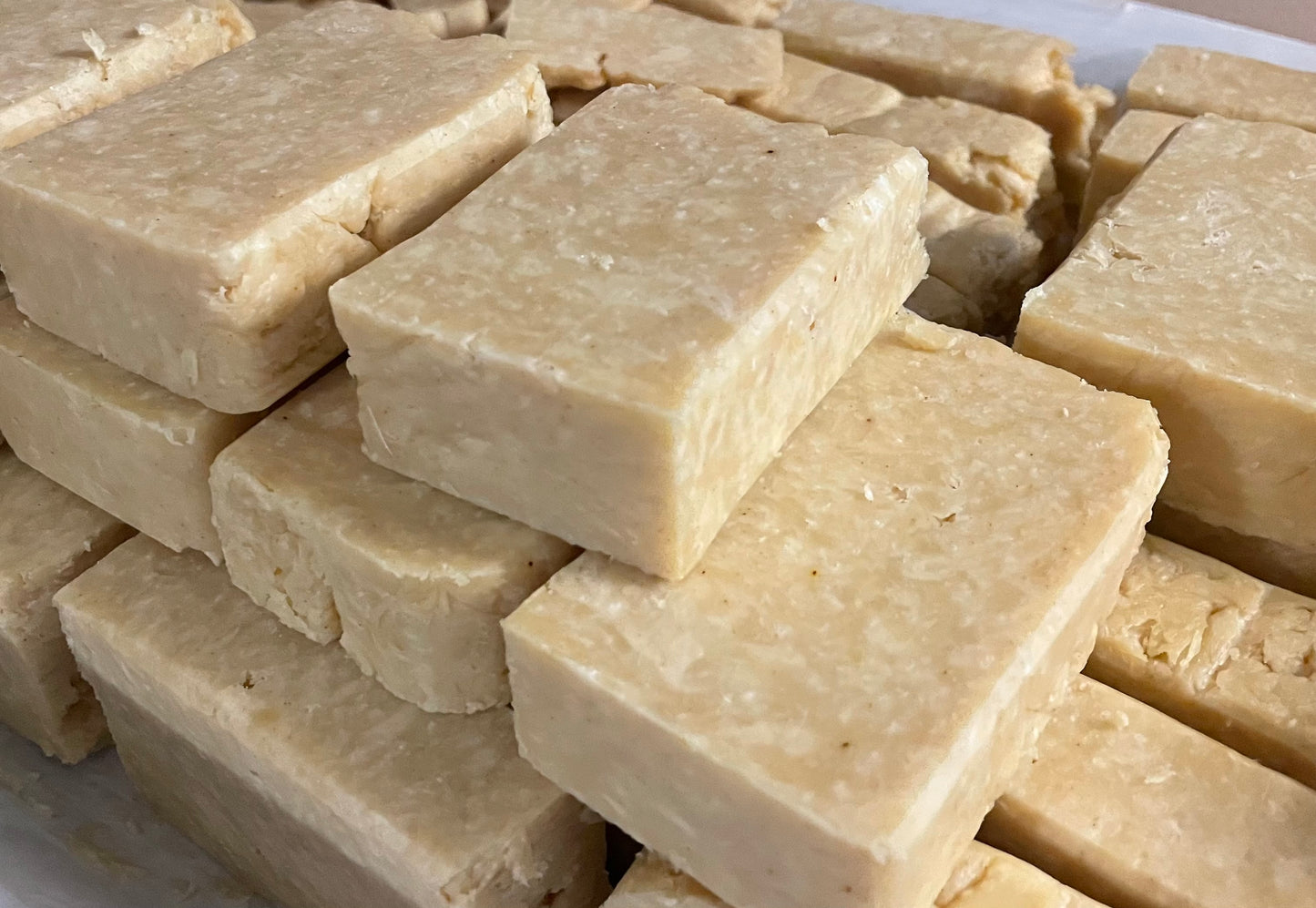 Stacked Citrus scented soap in three layers. They are light yellow with white specks.