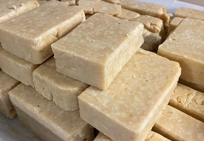 Stacked Citrus scented soap in three layers. They are light yellow with white specks.